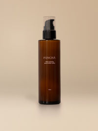 RISE Hydrating Hand & Body Lotion in amber glass on a warm studio backdrop