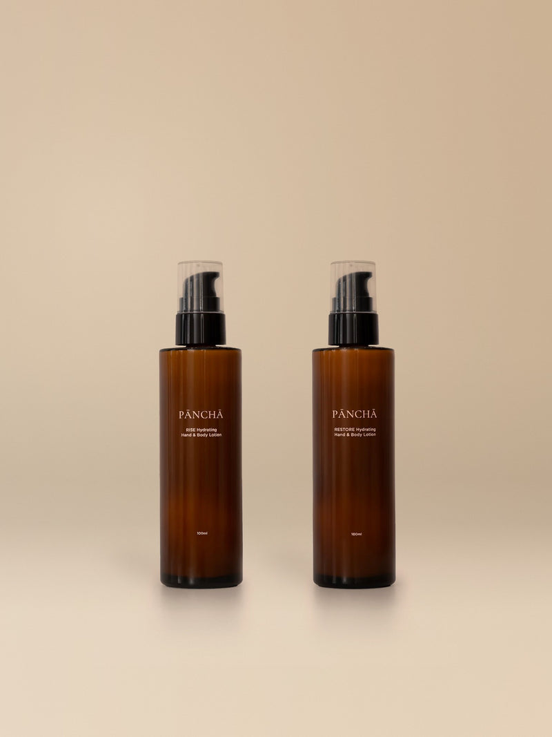 RISE and RESTORE Hand & Body Lotion Duo on a warm studio backdrop